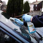 Car's glass exterior being cleaned by hand as shown in the Valet Guide