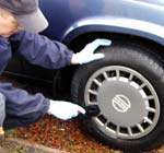 Car wheels being pre-brushed by hand for Valet Guide