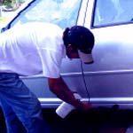 Car being cleaned from tar and glue for the Valet Guide