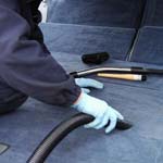 Car being vacuumed by hand for the Valet Guide