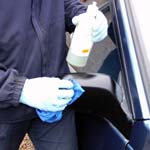 Car's exterior trim being dressed by hand in the Valet Guide
